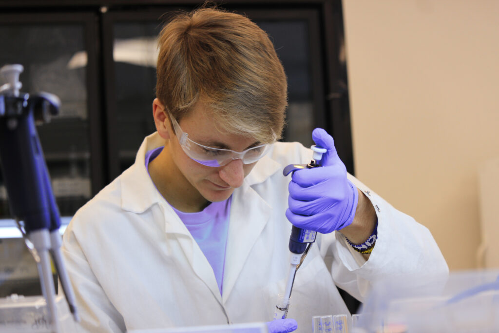 Scientist performing an ELISA assay kit