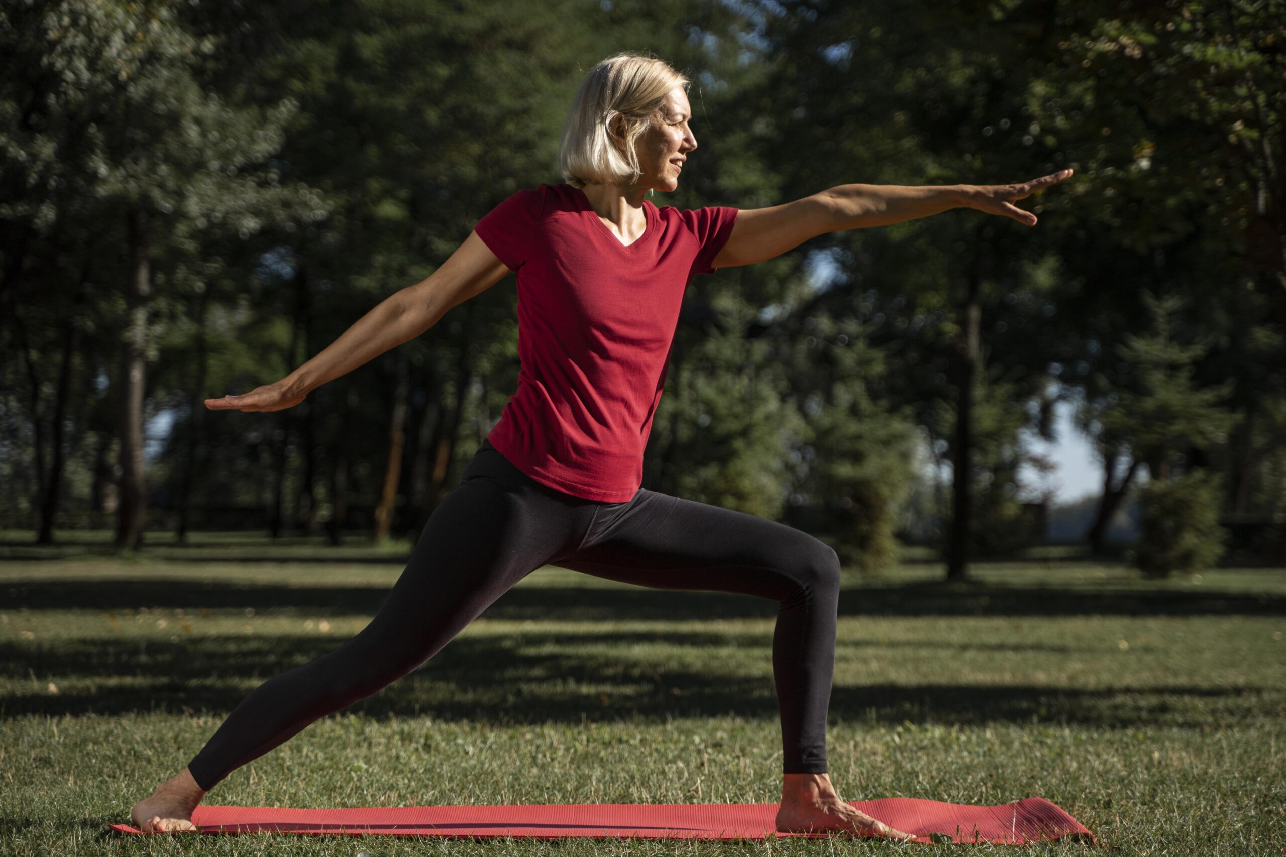 postmenopausal woman doing physical activity, stretching in a park